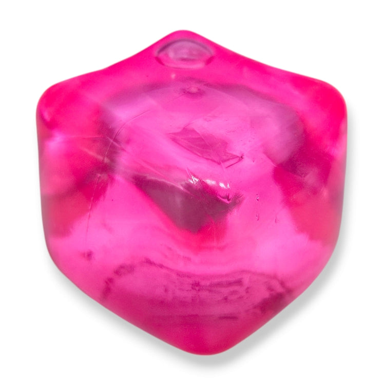 A hand squeezing a pink stress cube toy, which is designed to be squished and squeezed back to its original shape.