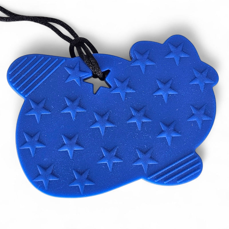 Blue bear-shaped object with star patterns on a white background