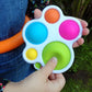 Colorful fidget toy held by a person outdoors