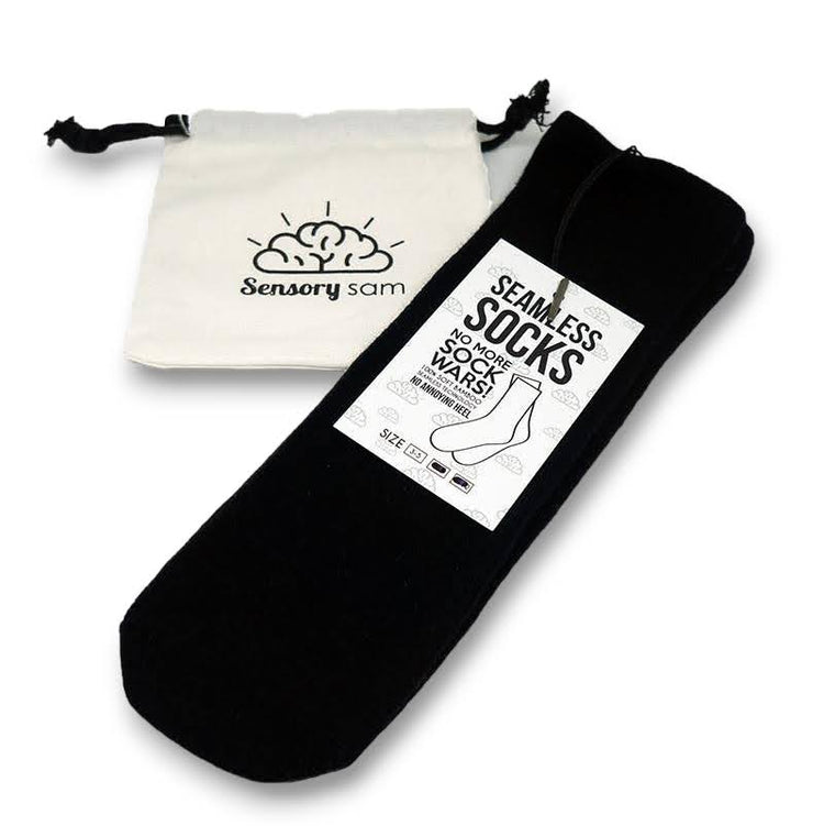 A two-pack of black bamboo seamless socks for kids, presented in a white drawstring bag with the logo &