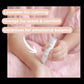 Baby holding a bottle with text about essential oils on a pink background