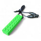 Green block-shaped object with a black cord on a white background