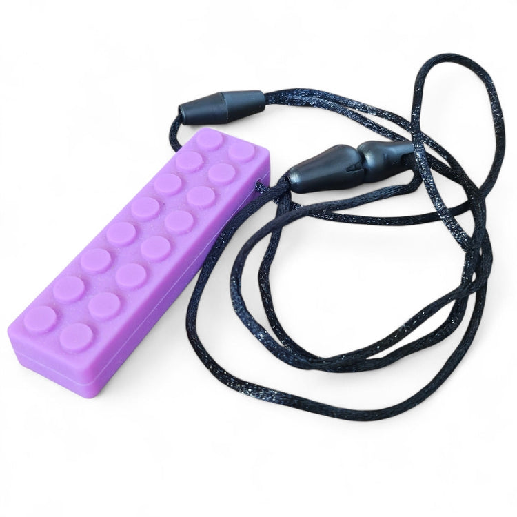 Purple block-shaped device with a black lanyard on a white background