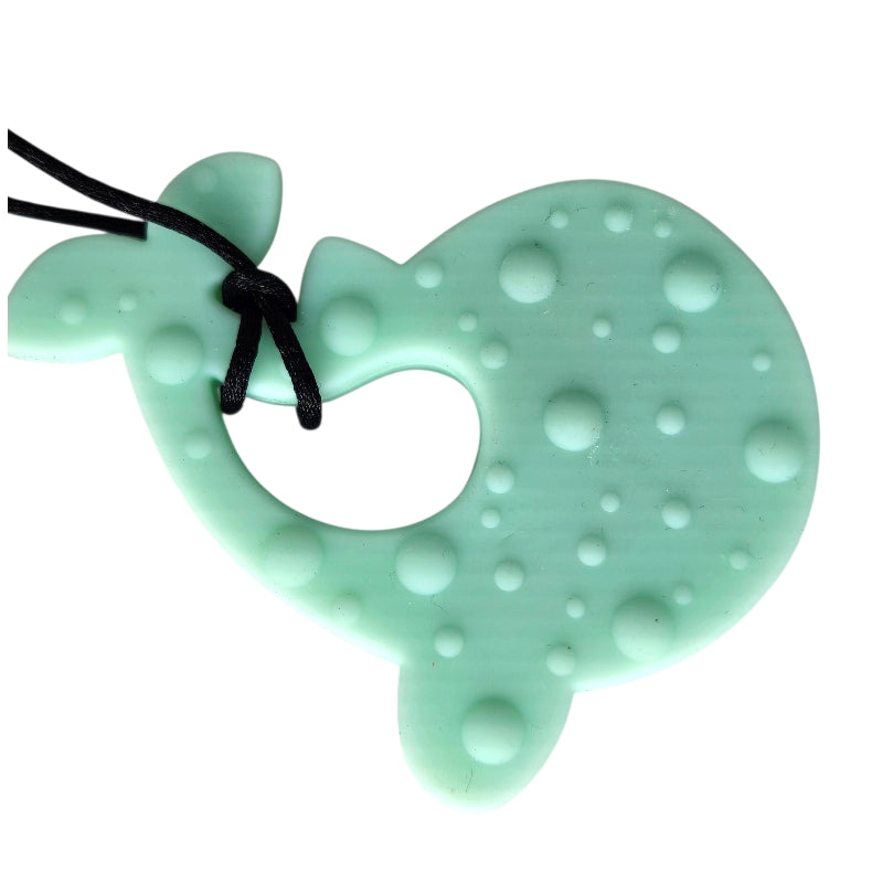 Mint green heart-shaped teething toy with black cord on a white background