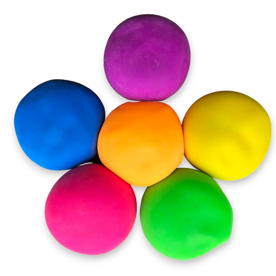 A collection of colorful giant stress balls arranged together, with colors including blue, purple, orange, yellow, pink, and green.