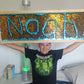 Child holding a large sequin sign with &