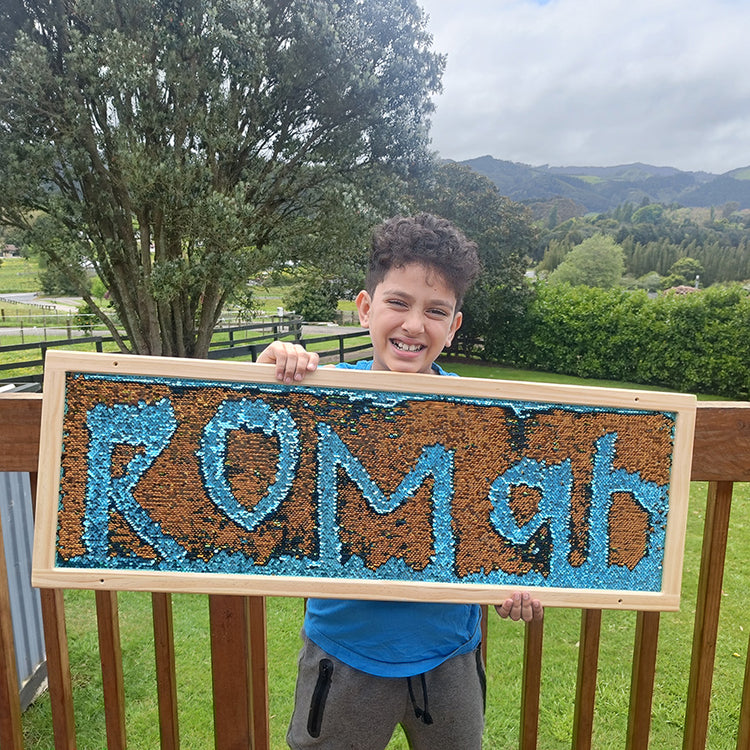 Child holding a sign with &