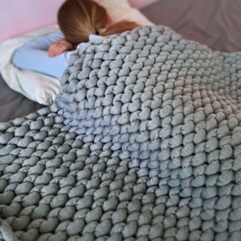 Close-up of a textured gray rug with a baby&