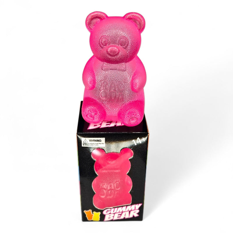 Pink gummy bear toy with packaging on a white background