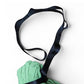Green bag with a black strap on a white background