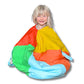 A child sitting cross-legged while inside a multicolored hideaway sack with openings for arms and legs, made of soft fabric.