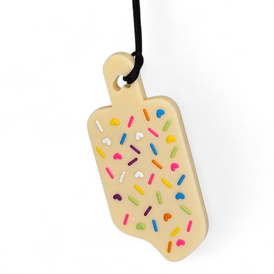 chew toy shaped like a ice cream cone with colorful sprinkles on a white background