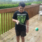 Child playing with a ball on a wooden deck