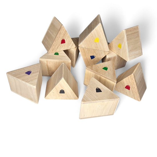 Wooden triangular pieces from the Kidpik Weight Memory Game with coloured dots.