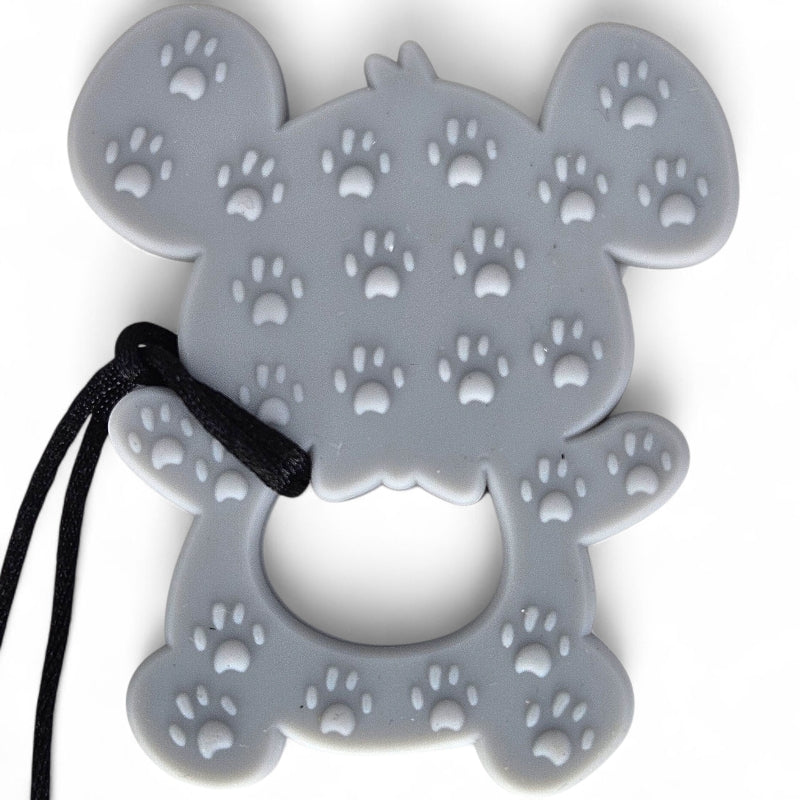 Gray silicone teething ring with paw prints on a white background