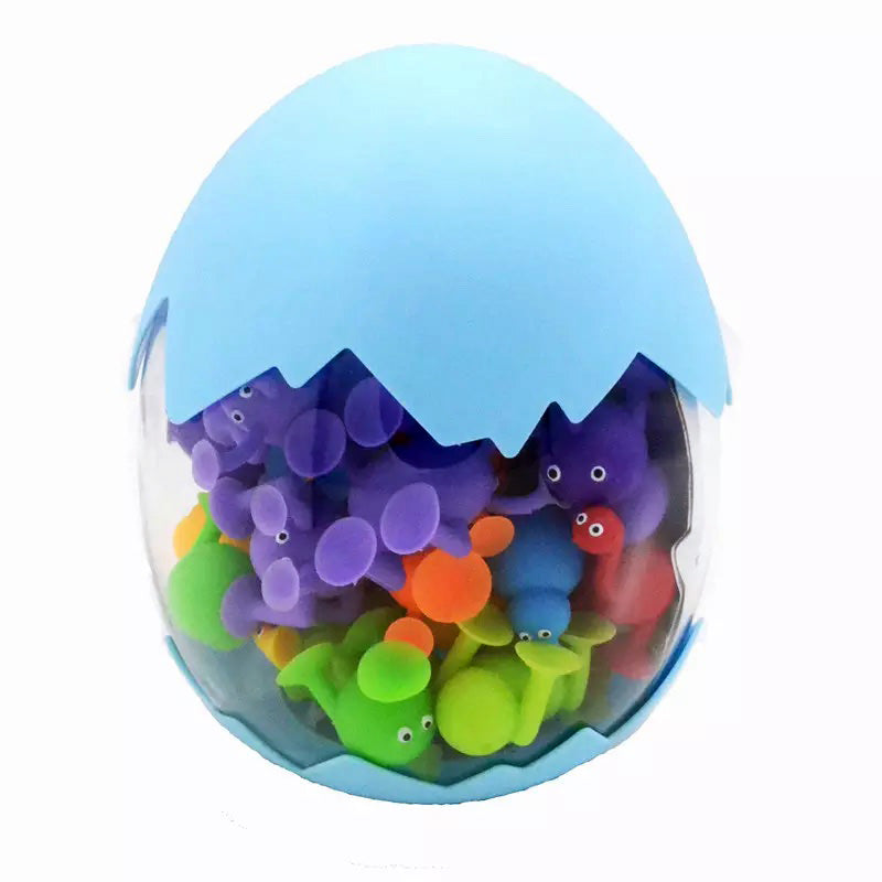 Colorful toy fish inside a transparent egg-shaped container on a white background