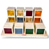 Colorful wooden cube puzzle with transparent sides, each containing small objects, on a white background. Brand &