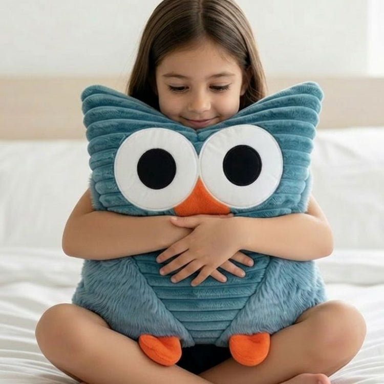 Child hugging a blue owl-shaped pillow on a bed