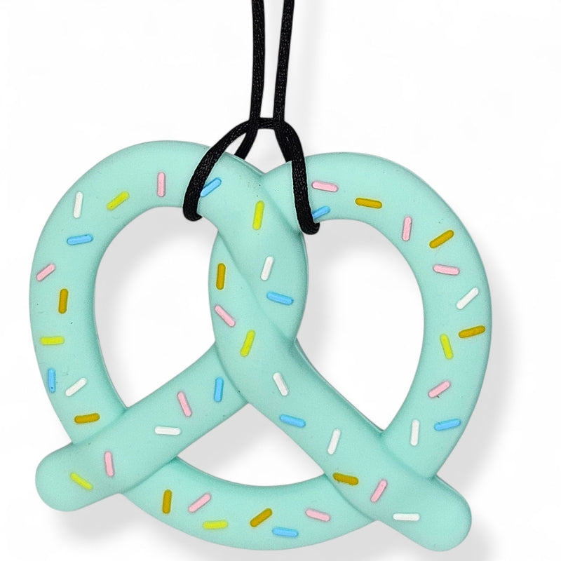 Light blue pretzel-shaped toy with colorful sprinkles on a white background