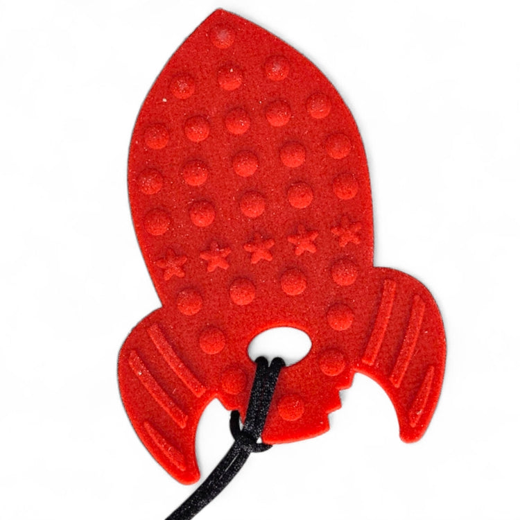 Red rocket-shaped object with a black string on a white background