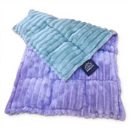 Two textured pillows, one blue and one purple, with a brand tag on a white background.