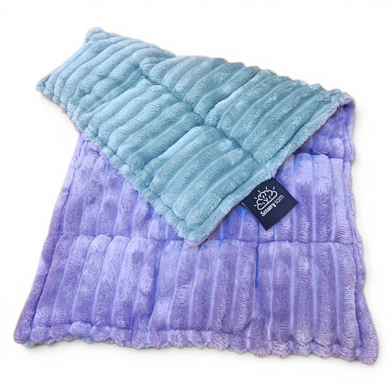 Two textured pillows, one blue and one purple, with a brand tag on a white background.