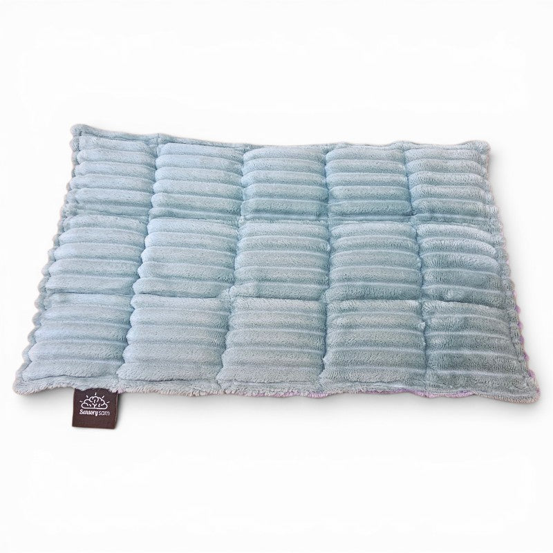 Blue textured pillow with a brand tag on a white background