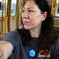 Woman wearing a Jurassic Park shirt on a train