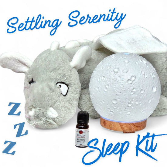 Sleep kit with plush toy, moon lamp, and essential oil bottle labeled &