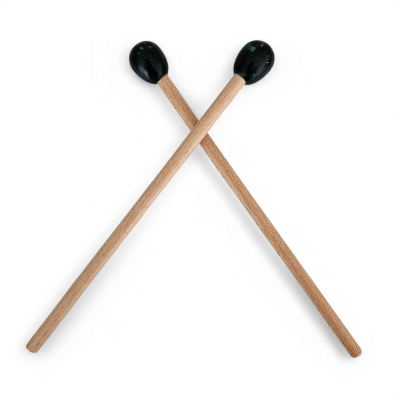 A pair of wooden spare zen drum sticks with black round mallet heads.