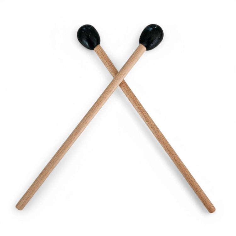 A pair of wooden spare zen drum sticks with black round mallet heads.