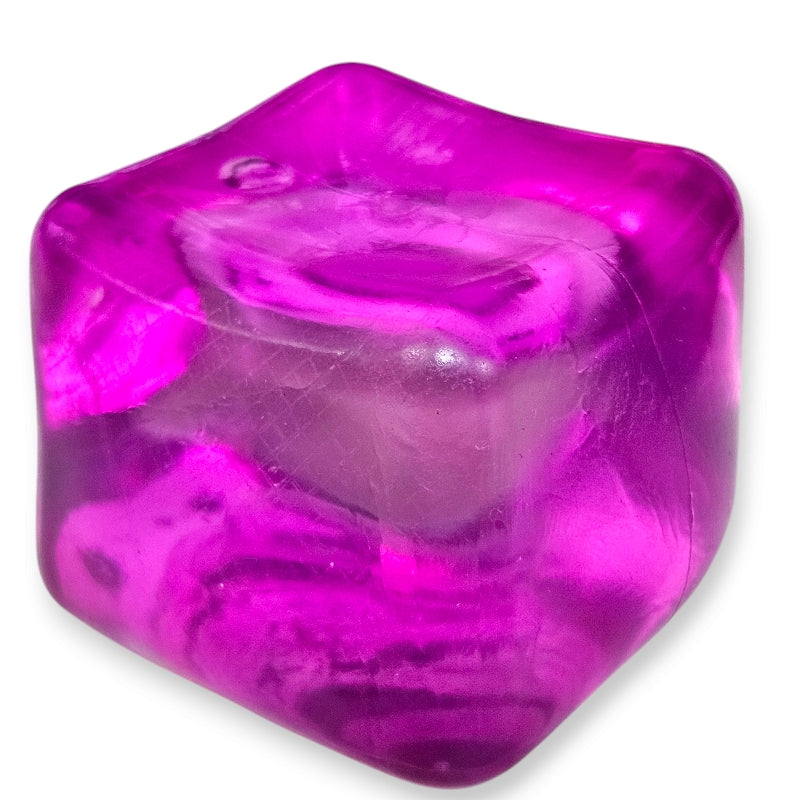 A hand squeezing a pink stress cube toy, which is designed to be squished and squeezed back to its original shape.