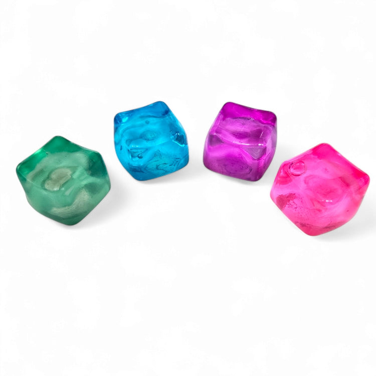 A hand squeezing a pink stress cube toy, which is designed to be squished and squeezed back to its original shape.