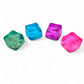 A hand squeezing a pink stress cube toy, which is designed to be squished and squeezed back to its original shape.