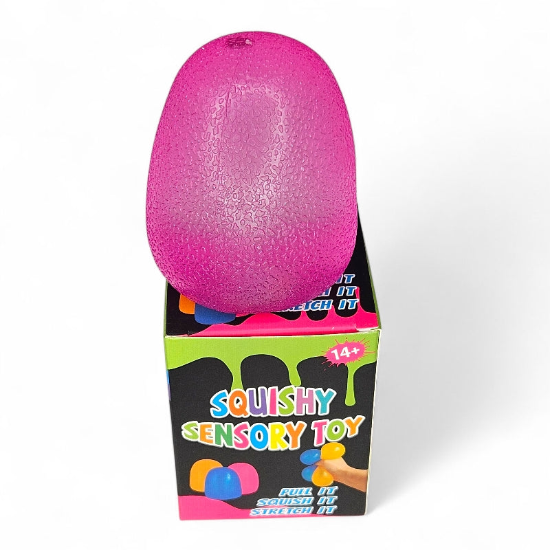 Pink squishy sensory toy with packaging on a white background