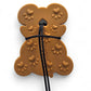 Brown dog treat shaped like a bone with heart patterns on a white background