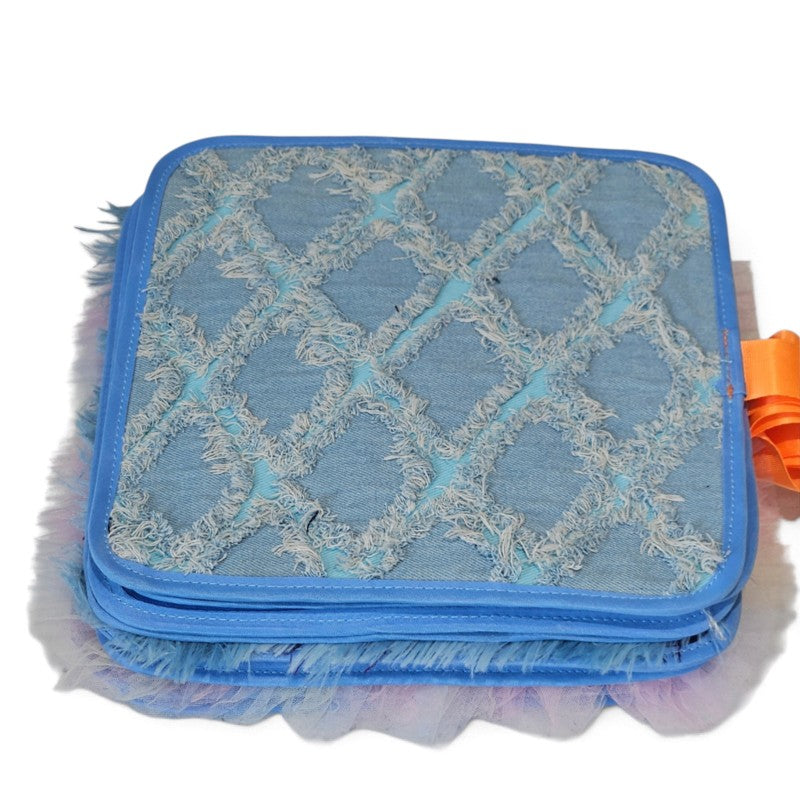 Blue textile page with a raised fringed diamond pattern from the Texture Discovery Book.