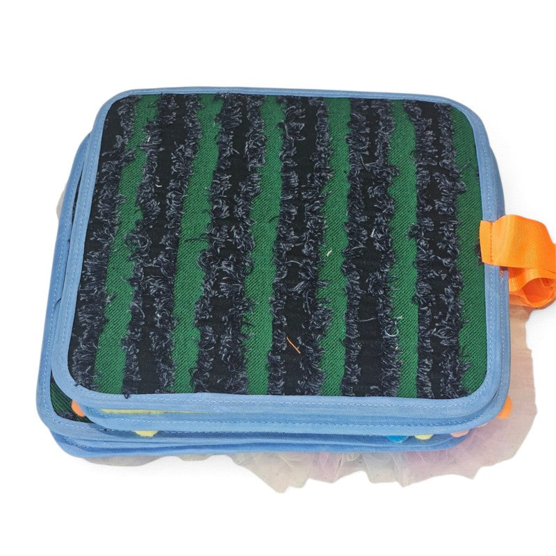 Texture Discovery Book page with green fabric and raised black vertical stripes, blue edging and an orange tab.