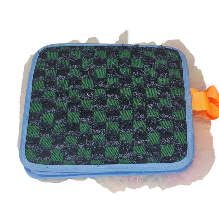 Texture Discovery Book page with a green and black woven check pattern, blue edging and an orange tab.