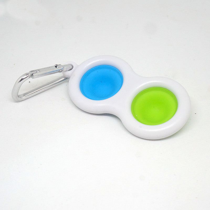 Keychain with blue and green silicone dots on a white background