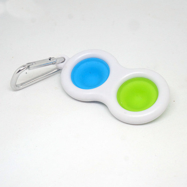 Keychain with blue and green silicone dots on a white background