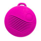 Front view of the pink round vibrating pendant with a loop at the top and textured ridges.