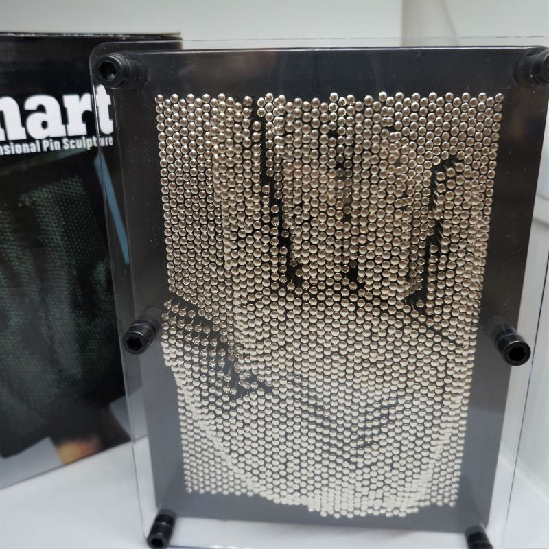 A 3-D Pin Art sculpture with moveable metal pins arranged in a 3D grid pattern, displaying a basic three-dimensional shape.