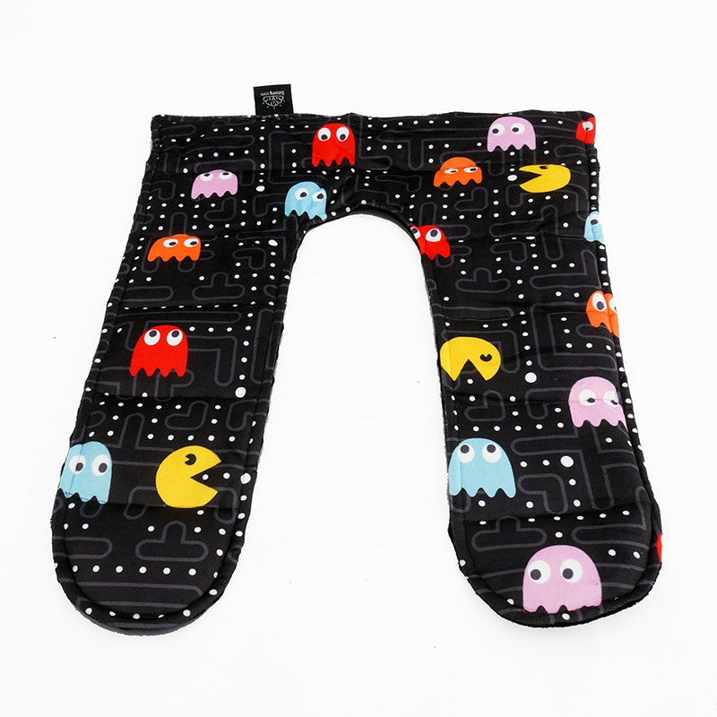 A weighted shoulder hugger lap pad with an 80s arcade pattern featuring colorful video game characters on a black background.
