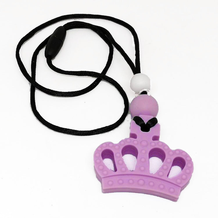 A Chewie Necklace with a purple crown-shaped chewable piece attached to a black cord with a breakaway clasp.