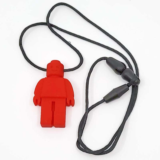 A red silicone Chewie necklace designed to look like a Lego block character, with a black flexible cord and gray beads.