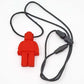 A red silicone Chewie necklace designed to look like a Lego block character, with a black flexible cord and gray beads.