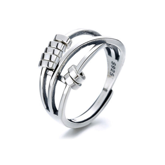 A sterling silver fidget ring with movable beads on a finger, showing a polished silver finish.