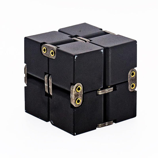 A black aluminium infinity cube fidget toy with visible hinges and yellow accents.