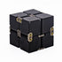 A black aluminium infinity cube fidget toy with visible hinges and yellow accents.